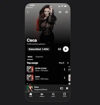 a black phone with a music app displaying an image of a woman