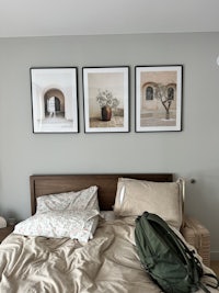 a bed with a backpack on top of it
