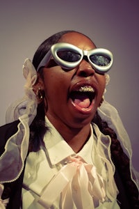a woman wearing sunglasses with her mouth open