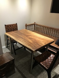 a wooden table and chairs in a room