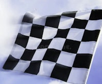 a black and white checkered flag flying in the wind royalty free stock photos