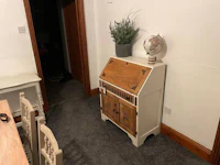 a small desk in a room with a globe on it