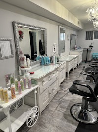 a hair salon with a mirror and chairs