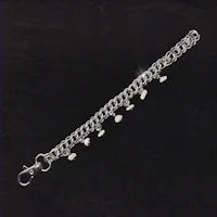 a silver chain with pearls on it