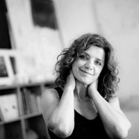 a black and white photo of a woman with curly hair