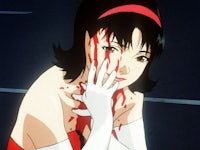 a woman in a red dress with blood on her face