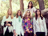 a group of men posing for a photo in the woods