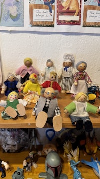 a wooden table with a lot of dolls on it
