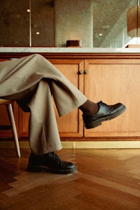 a person sitting on a chair in a kitchen