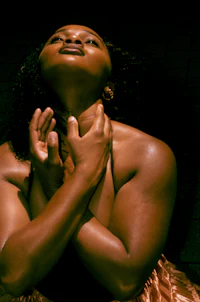 a woman posing with her hands on her chest