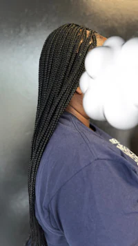 a woman with braids and a cloud over her head