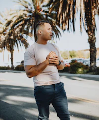 a man wearing a pink t - shirt and blue pants