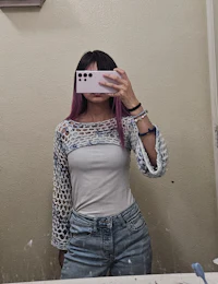 a woman taking a selfie in a mirror