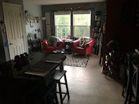 a living room with a table and chairs