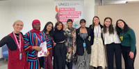 a group of women posing for a photo in an office