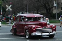 a red car driving down the street