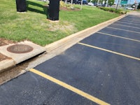 a manhole in the middle of a parking lot
