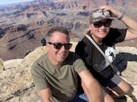 two people posing for a photo at the grand canyon