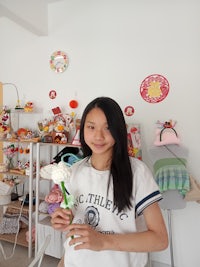 a girl holding a flower