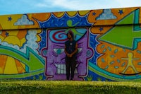 a man standing in front of a colorful wall