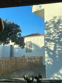 a view of a house through the window of a car