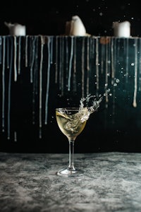 a martini glass with a splash of water on it