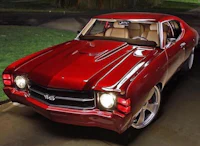 a red chevrolet chevelle is parked in a driveway