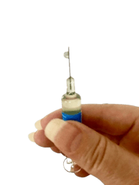 a person holding a small blue and white syringe