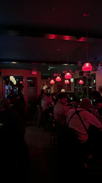 a group of people sitting at a table in a restaurant