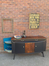 a black and blue sideboard with a picture on it