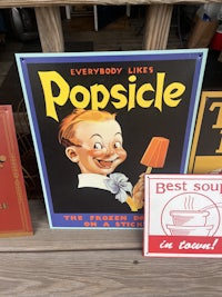 vintage popsicle signs on a wooden deck