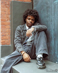 a man is sitting on the steps of a building