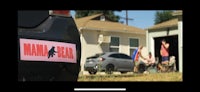 a car is parked in front of a house with a pink sticker on it