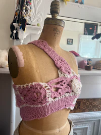 a mannequin with a pink crocheted top