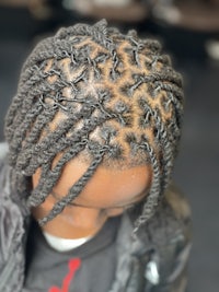 a young girl with braids in her hair