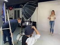 a group of people are taking pictures in a studio