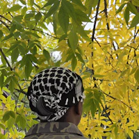 a person wearing a headband in front of a tree