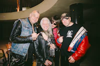 three men in leather jackets posing for a picture
