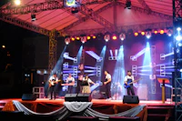 a group of people performing on stage at night