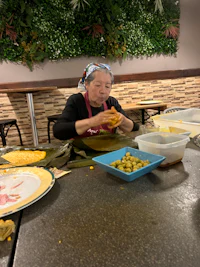 a woman is preparing food at a table