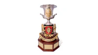a silver and gold trophy on a wooden base