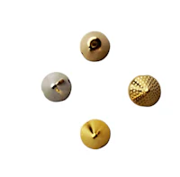 four gold metal buttons on a white background
