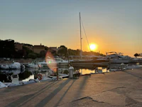 a boat docked in a marina at sunset