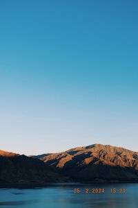 a lake with mountains in the background