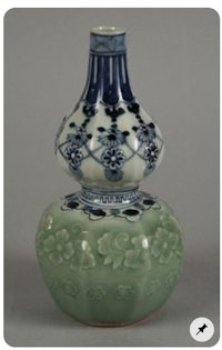 a pair of blue and white vases on top of each other