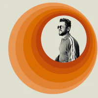an orange circle with a man's face in it