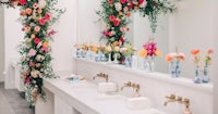 a bathroom decorated with flowers and mirrors