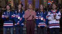 a group of people standing next to each other holding medals