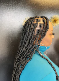 a woman with dreadlocks in front of a mirror