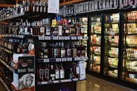 a row of bottles in a liquor store